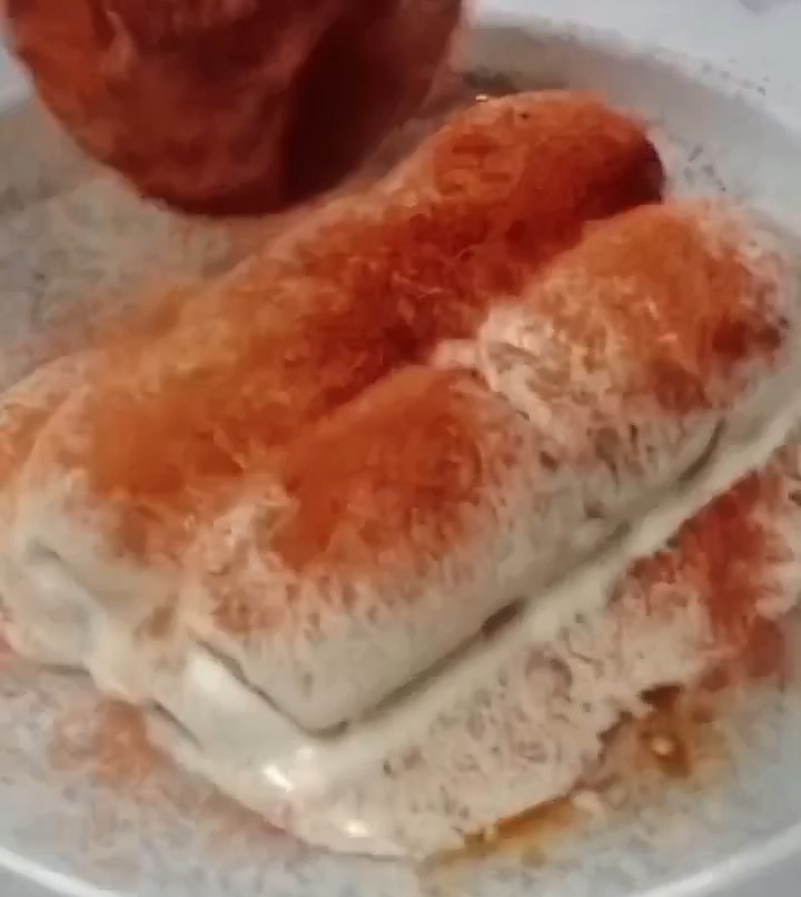 Dusting cocoa powder on top of No Bake Mini Tiramisu